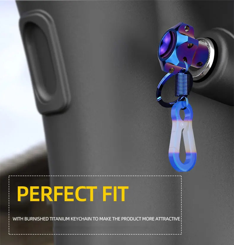 A close-up of a motorcycle key head cover featuring a polished titanium keychain attached to the product.