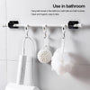 White adhesive curtain rod hooks mounted on a bathroom towel rack for hanging bath towels, balls, and brushes.