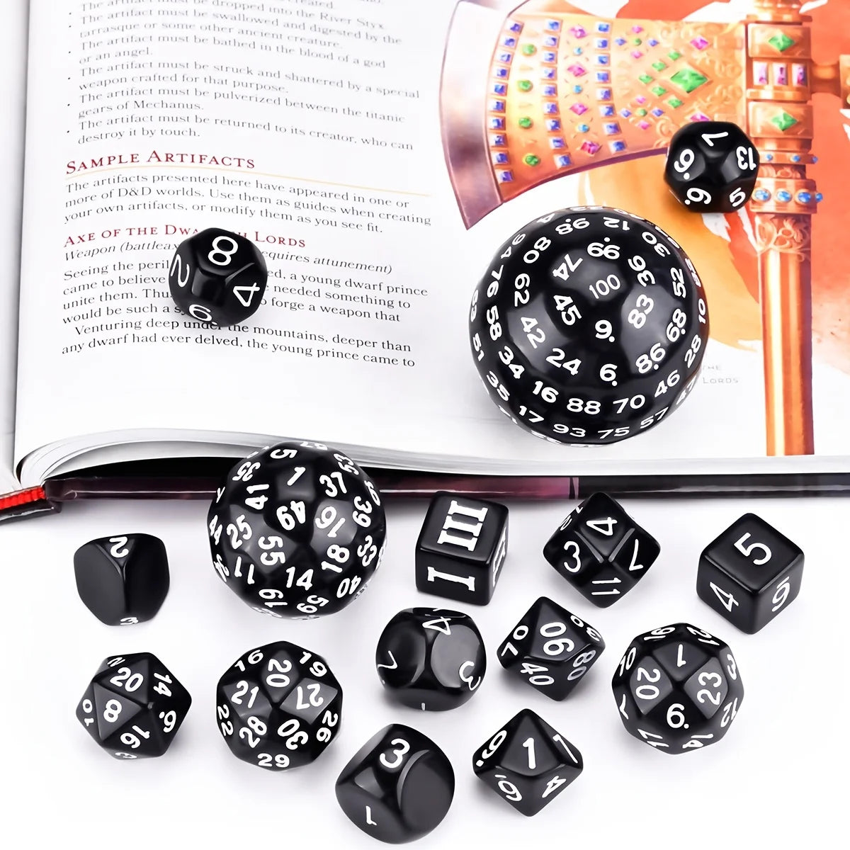 A set of 15 polyhedral dice including d8, d10, d12, and d20 dice displayed on a book.