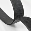 Close-up of black sew-on hook and loop tape showing the textured surface and flexible strip.