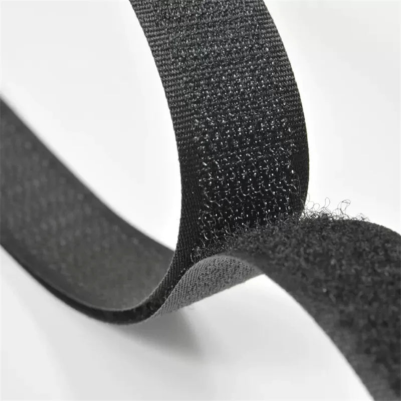 Close-up of black sew-on hook and loop tape showing the textured surface and flexible strip.