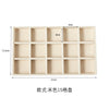 A light beige velvet jewelry organizer tray with 15 compartments.