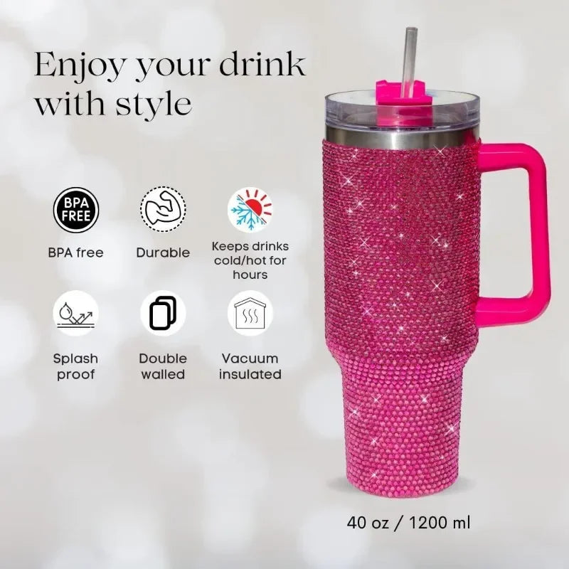 A pink rhinestone tumbler with a straw and handle is shown against a white background.