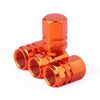 Set of four orange aluminum alloy wheel tire valve caps with a hexagon design