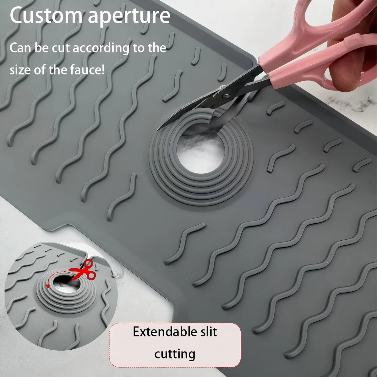 A silicone faucet mat with a custom aperture being cut by scissors to fit a faucet.