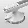 A white non-slip suction grab bar mounted on a bathroom surface.