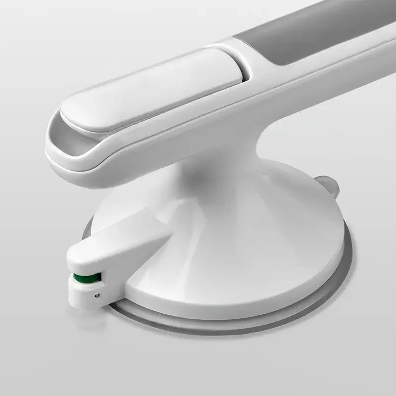 A white non-slip suction grab bar mounted on a bathroom surface.