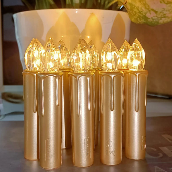 A set of five gold-colored flameless LED candles standing upright in a white bowl.