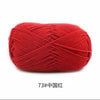 A ball of bright red 4-ply milk cotton yarn for knitting and crochet.