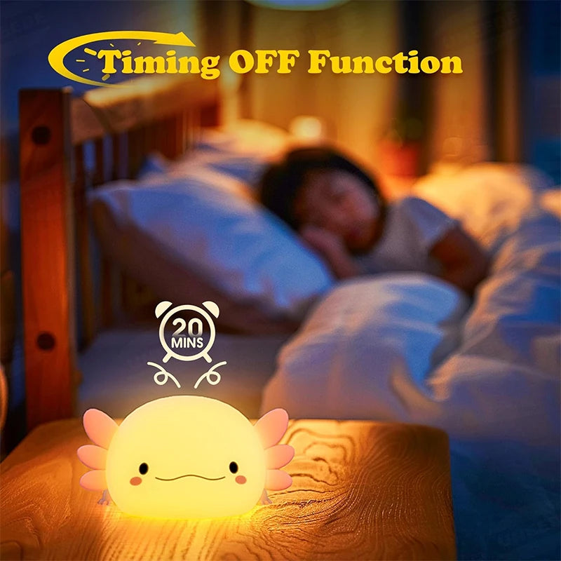 A glowing axolotl night light rests on a wooden surface in a bedroom setting.