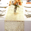 Metallic gold glitter table runner set for weddings and parties with white plates and floral centerpiece
