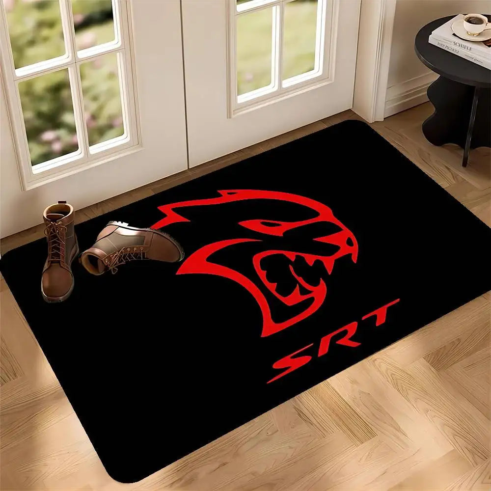 A black doormat featuring a red stylized lion head design on a light wood floor.
