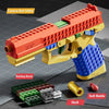 A yellow building block toy pistol with an orange barrel and blue grip, shown next to its shell and building blocks.