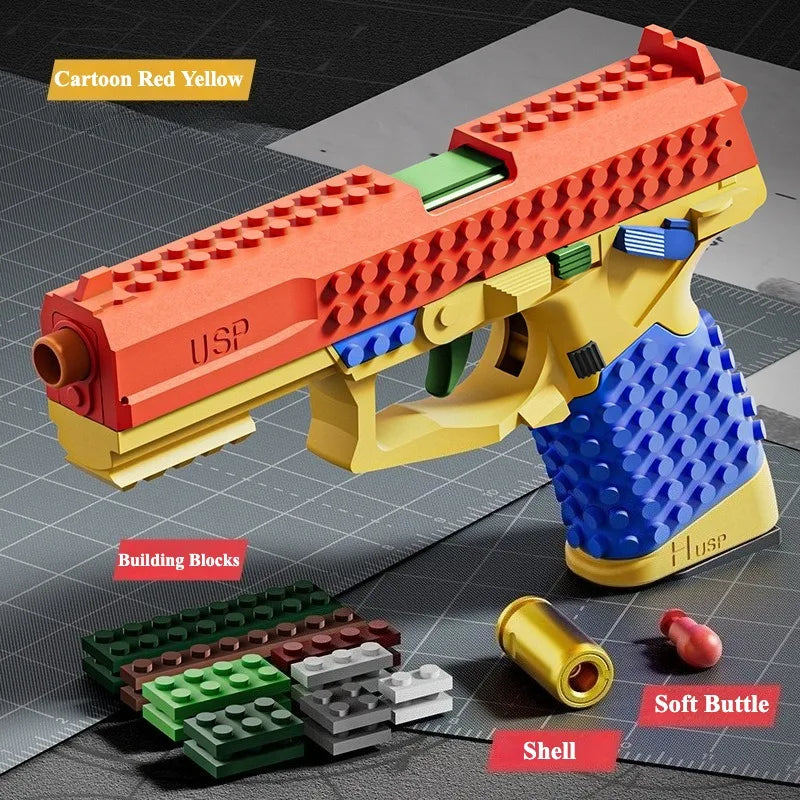A yellow building block toy pistol with an orange barrel and blue grip, shown next to its shell and building blocks.