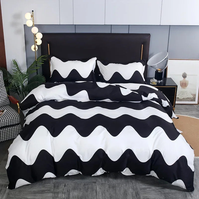 A black and white striped geometric duvet cover set with pillows displayed on a bed.
