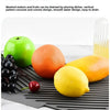 A silicone dish drying mat is shown with various fruits like apples, oranges, and lemons placed on it.