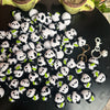 A pile of handmade crochet kitten keychains featuring cute panda and cartoon animal designs.