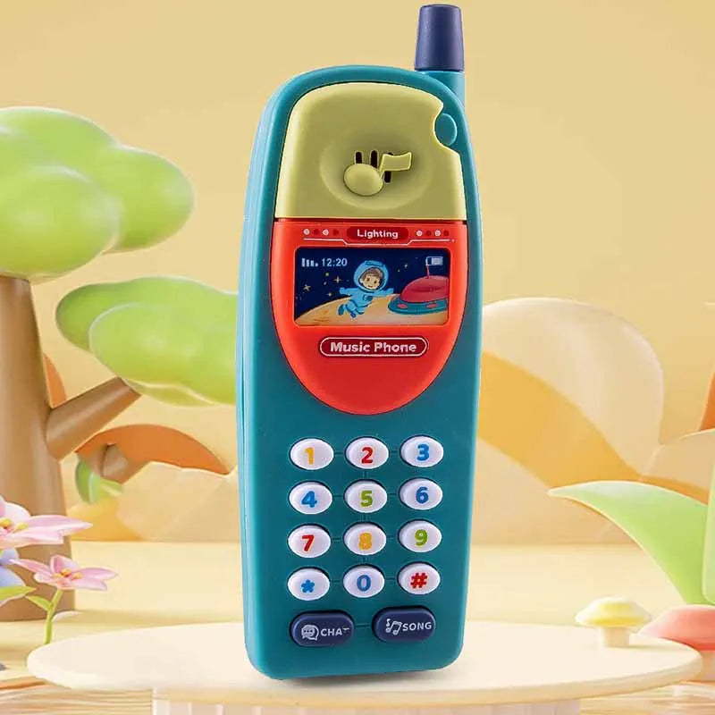 A teal kids learning toy smartphone with a keypad and speaker is displayed on a light wooden surface.