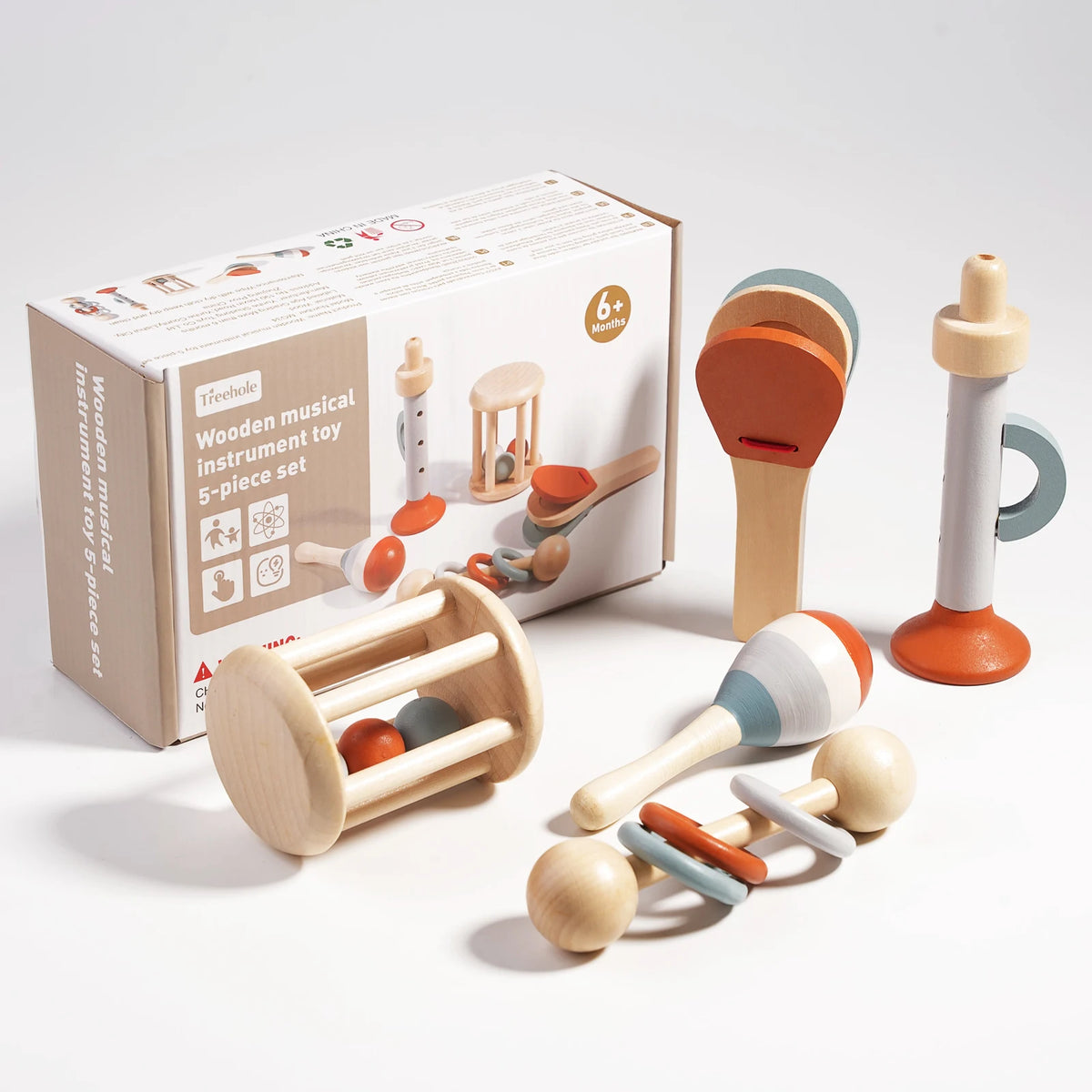 A box of wooden musical instrument toy showing various wooden instruments like a rattle and a small wooden bell.