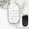 A clear plastic key fob cover for a car key, showing panic and unlock buttons, next to a black replacement key.