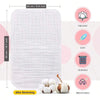 A white organic soft and durable muslin burp cloth shown next to a bundle of cotton balls.
