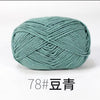 A ball of teal colored 4-ply milk cotton yarn for knitting and crochet.