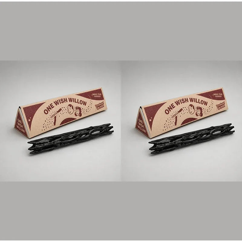 A black willow wood wishing stick with a gift box is shown on a light gray background.