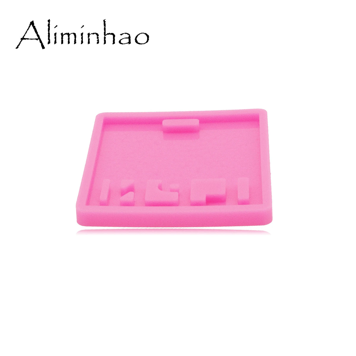 A pink silicone resin mold with a rectangular shape and molded features for making badge backings or keychains.