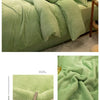 A light green cozy flannel duvet cover with a zipper, shown draped on a bed.