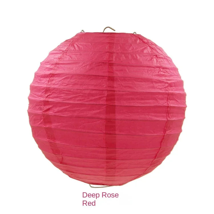 A round pink paper lantern with vertical folds, colored Deep Rose Red.