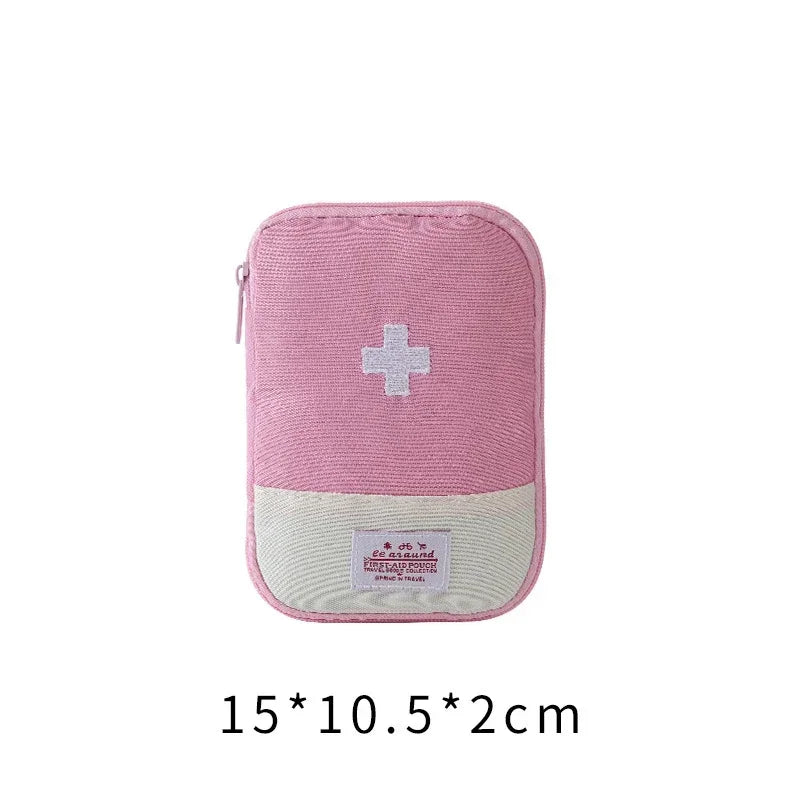 A pink fabric organizer bag with a white cross emblem and a beige patch on the front.