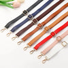 A collection of adjustable leather bag straps in various colors including black, navy blue, brown, red, and white.