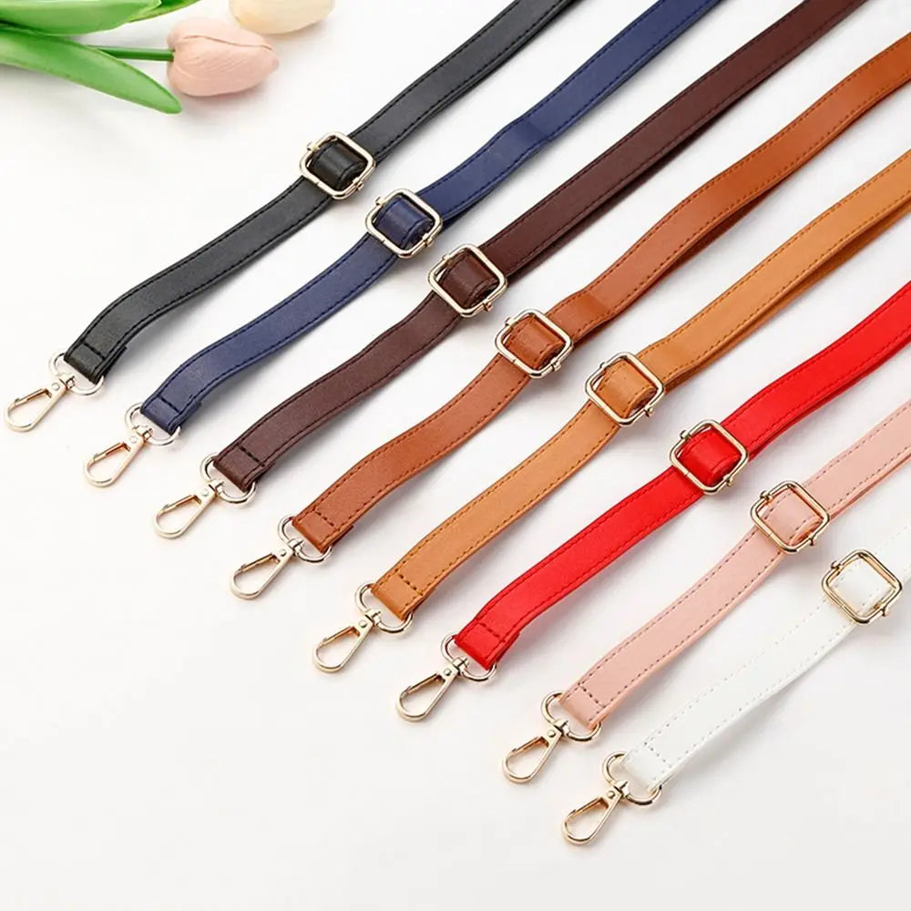 A collection of adjustable leather bag straps in various colors including black, navy blue, brown, red, and white.