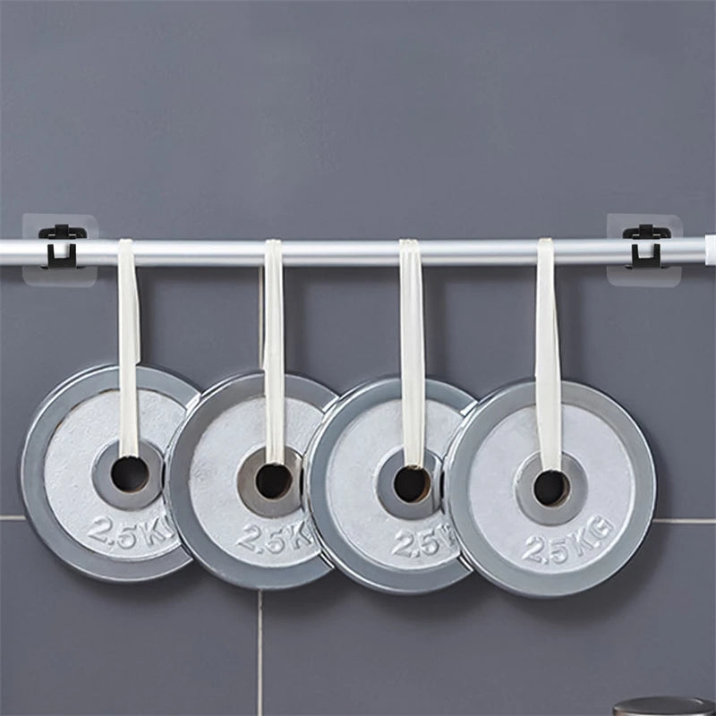 A set of two silver self-adhesive no-drill curtain rod brackets with white cords are hanging on a white rod.