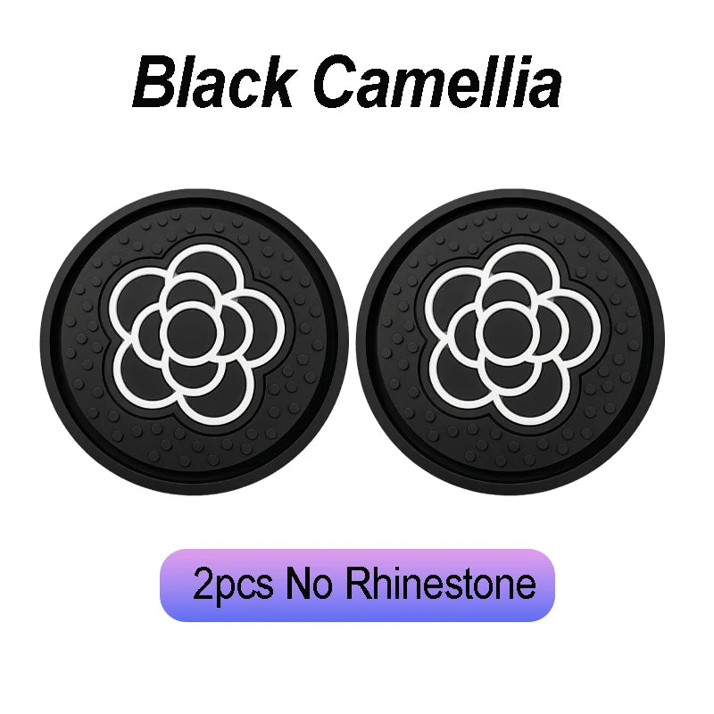 Two black non-slip waterproof coasters featuring a white camellia paw pattern.