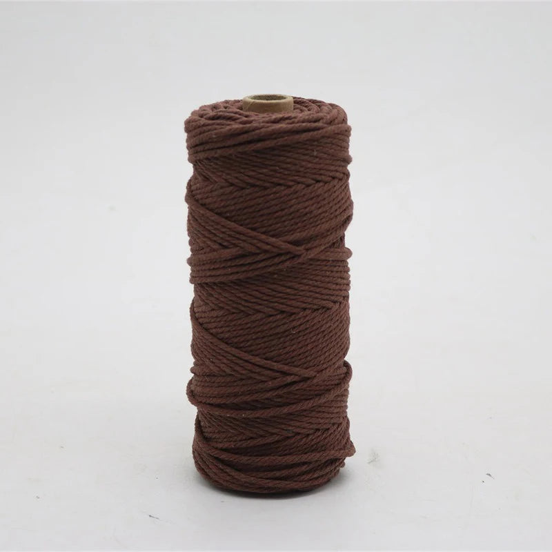 A spool of dark brown macrame cord, 3mm/4mm thickness, used for crafting.