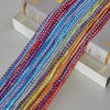 A close-up of colorful boho tassel string curtain cords in various shades of blue, pink, orange, and purple.