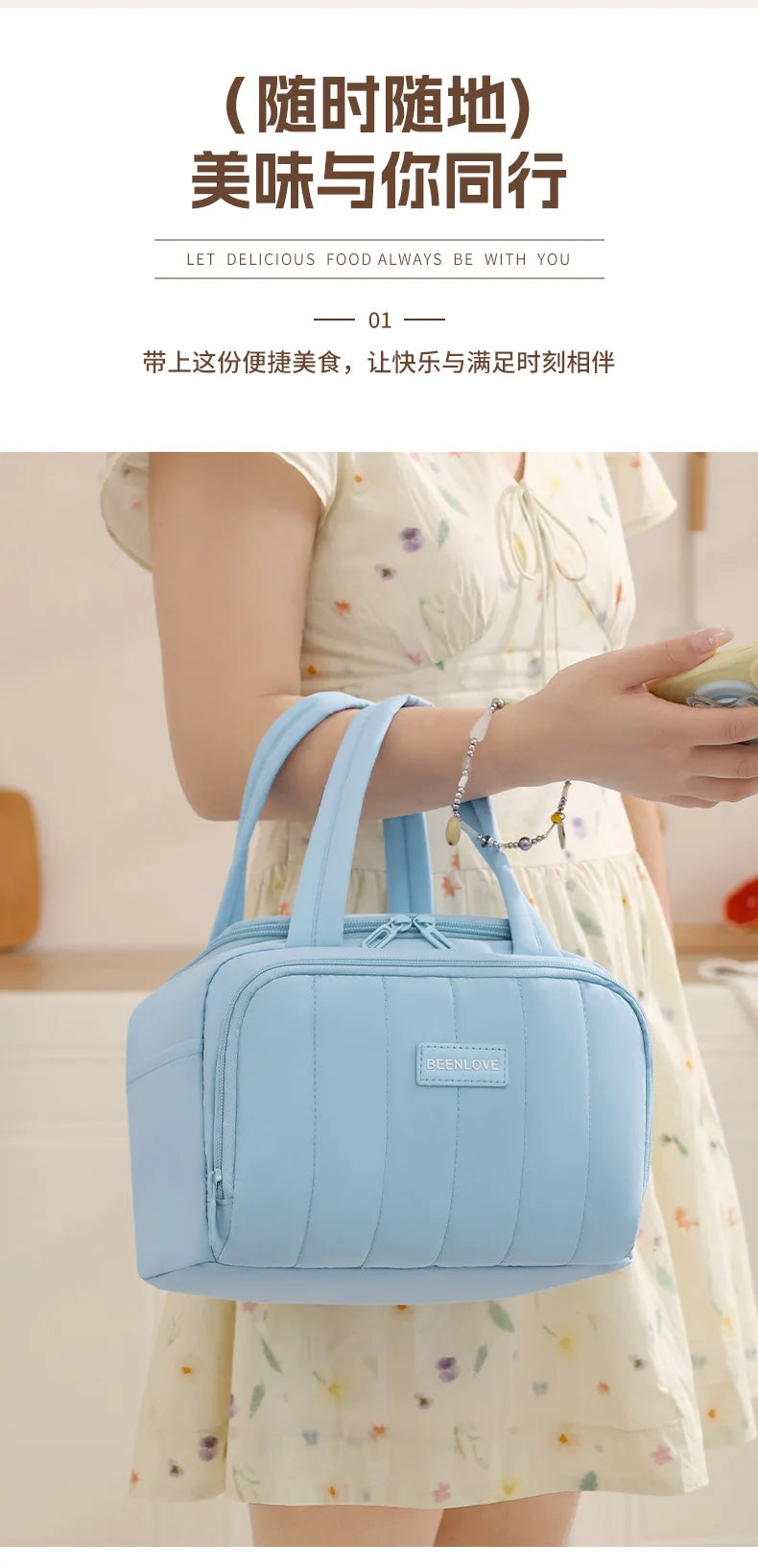 A light blue quilted insulated lunch tote bag being held by a woman in a white floral dress.