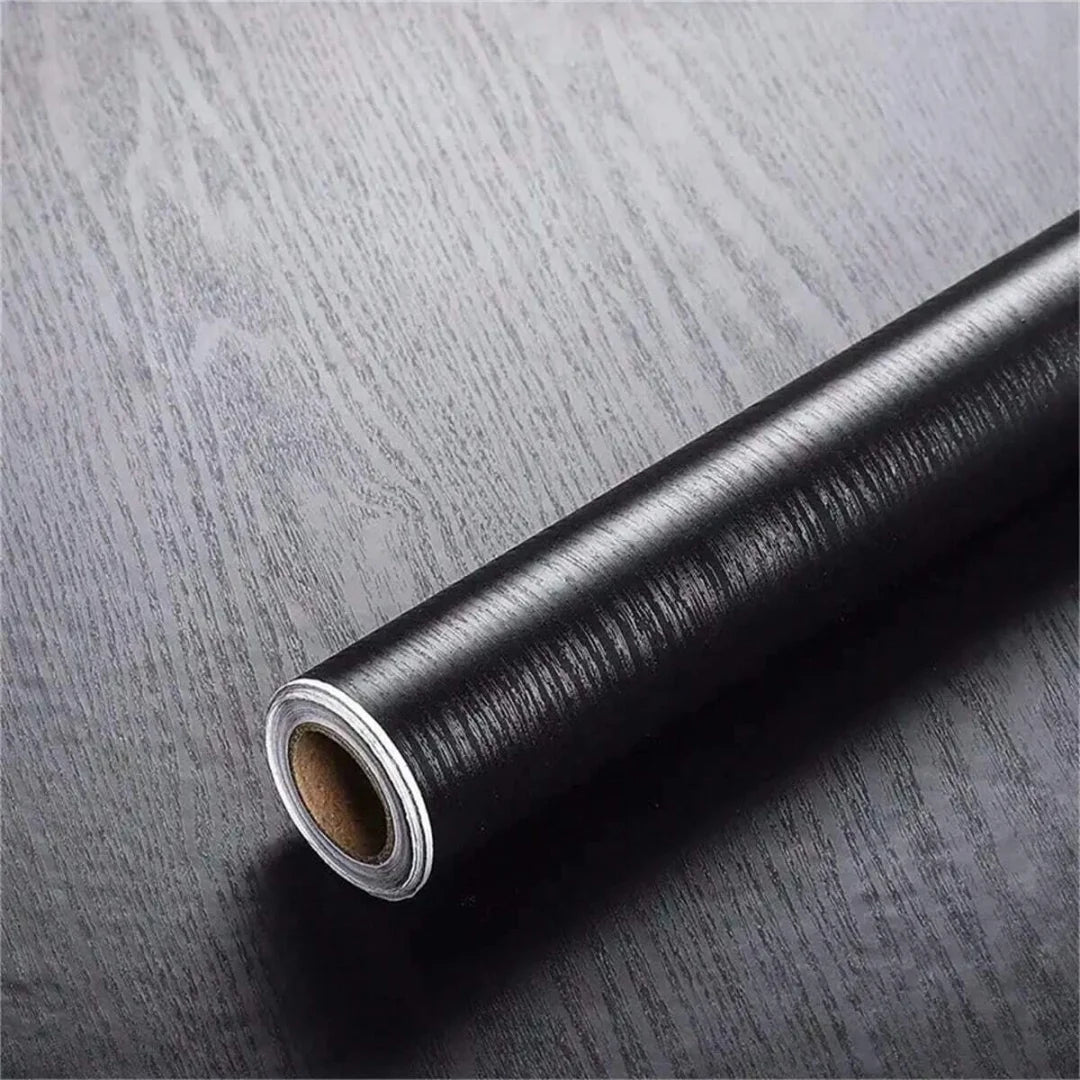 Roll of black self-adhesive wood grain cabinet and furniture refacing film