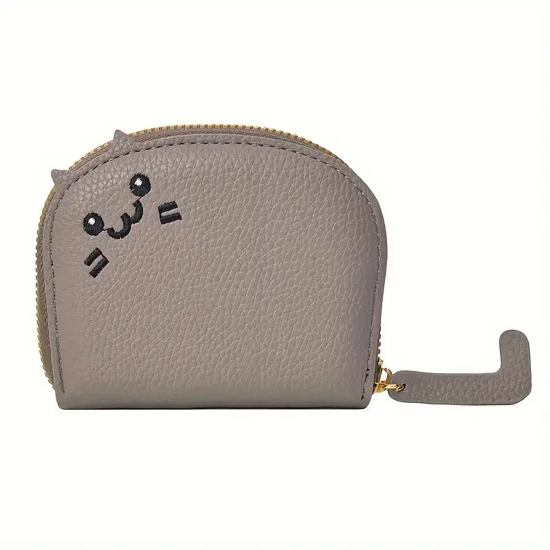 A light beige cartoon cat-shaped PU leather card wallet with a stitched face design.