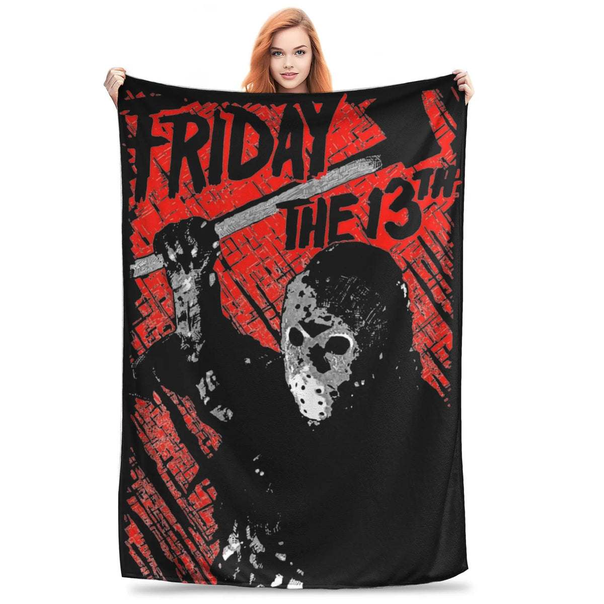 A woman holds up a black fleece throw blanket featuring a distressed graphic of Friday the 13th and the 13th.