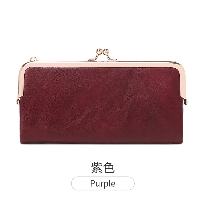 A maroon leather wallet with gold hardware shown against a white background.