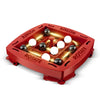 A red jumping pirates board game with a square board and various round pieces.