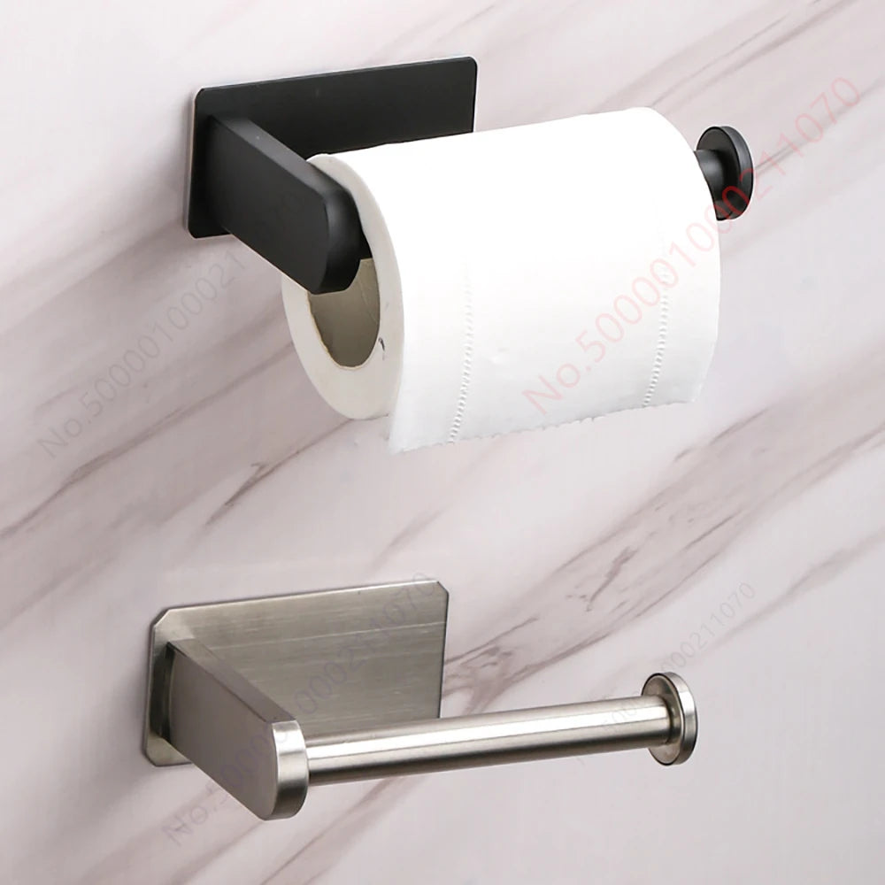 A silver stainless steel toilet paper holder mounted on a marble surface.