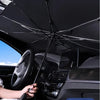 A black foldable windshield sunshade is shown inside a car, covering the interior for protection.