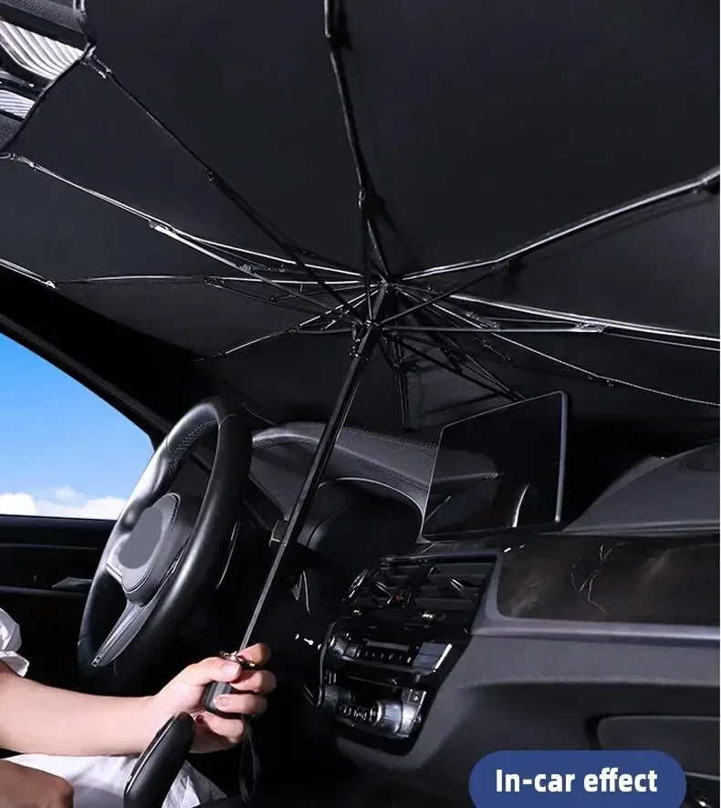 A black foldable windshield sunshade is shown inside a car, covering the interior for protection.
