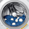 A set of three white natural wool dryer balls placed inside the drum of a washing machine.