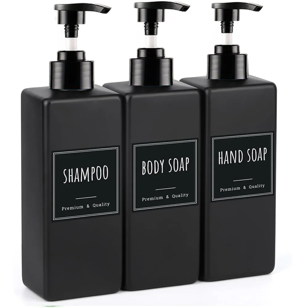 A three-pack of black refillable soap dispenser bottles with pump tops and labels for shampoo, body soap, and hand soap