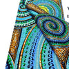 Close-up of pink glitter African wax print fabric featuring swirling patterns in teal, green, and orange tones.