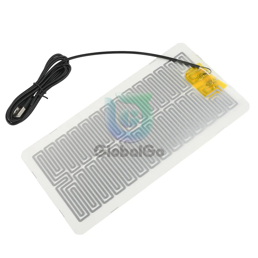 A yellow heating pad with a black cord is shown on a white surface.